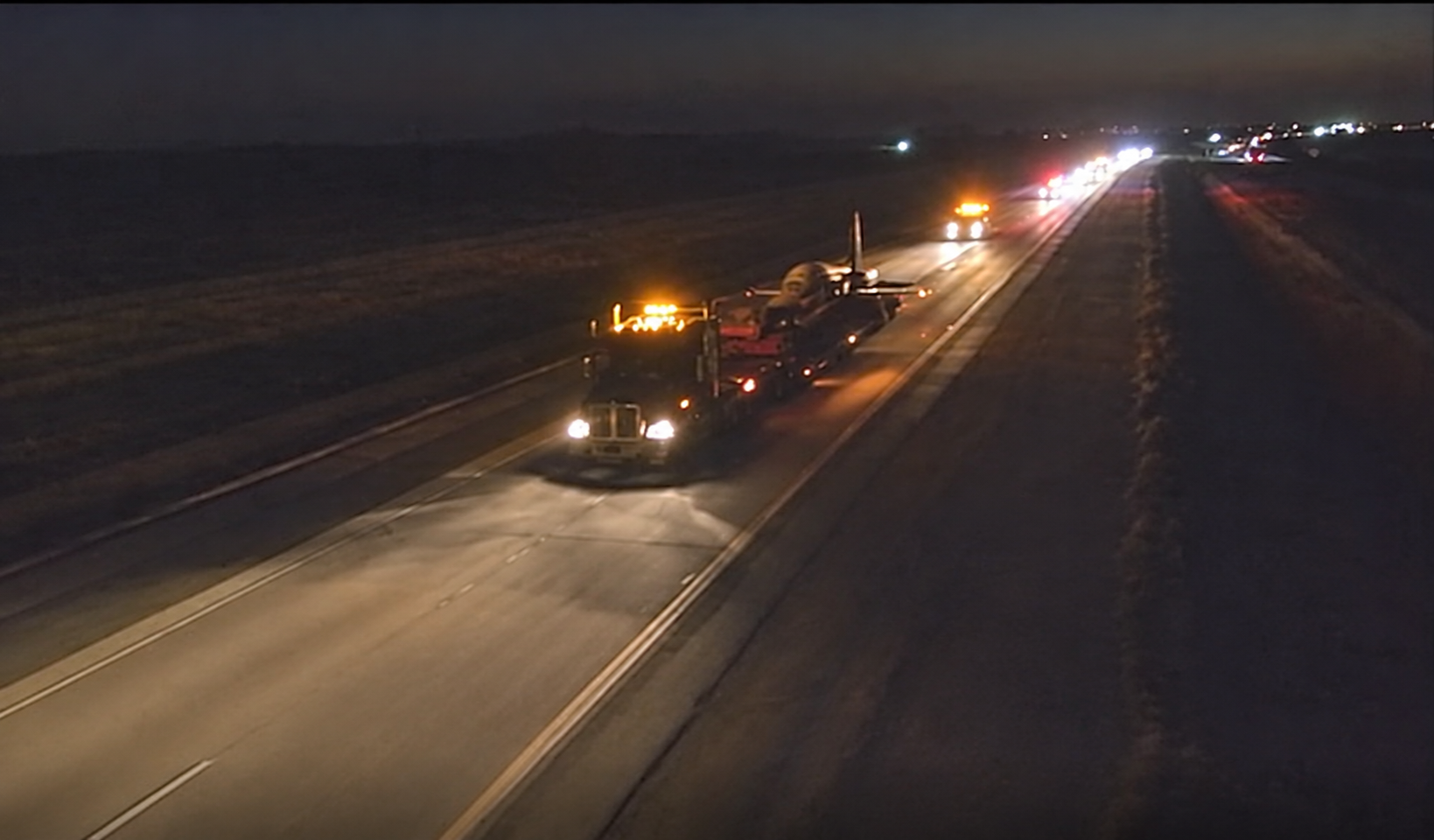 The aircraft transport convoy traveling along a highway at night